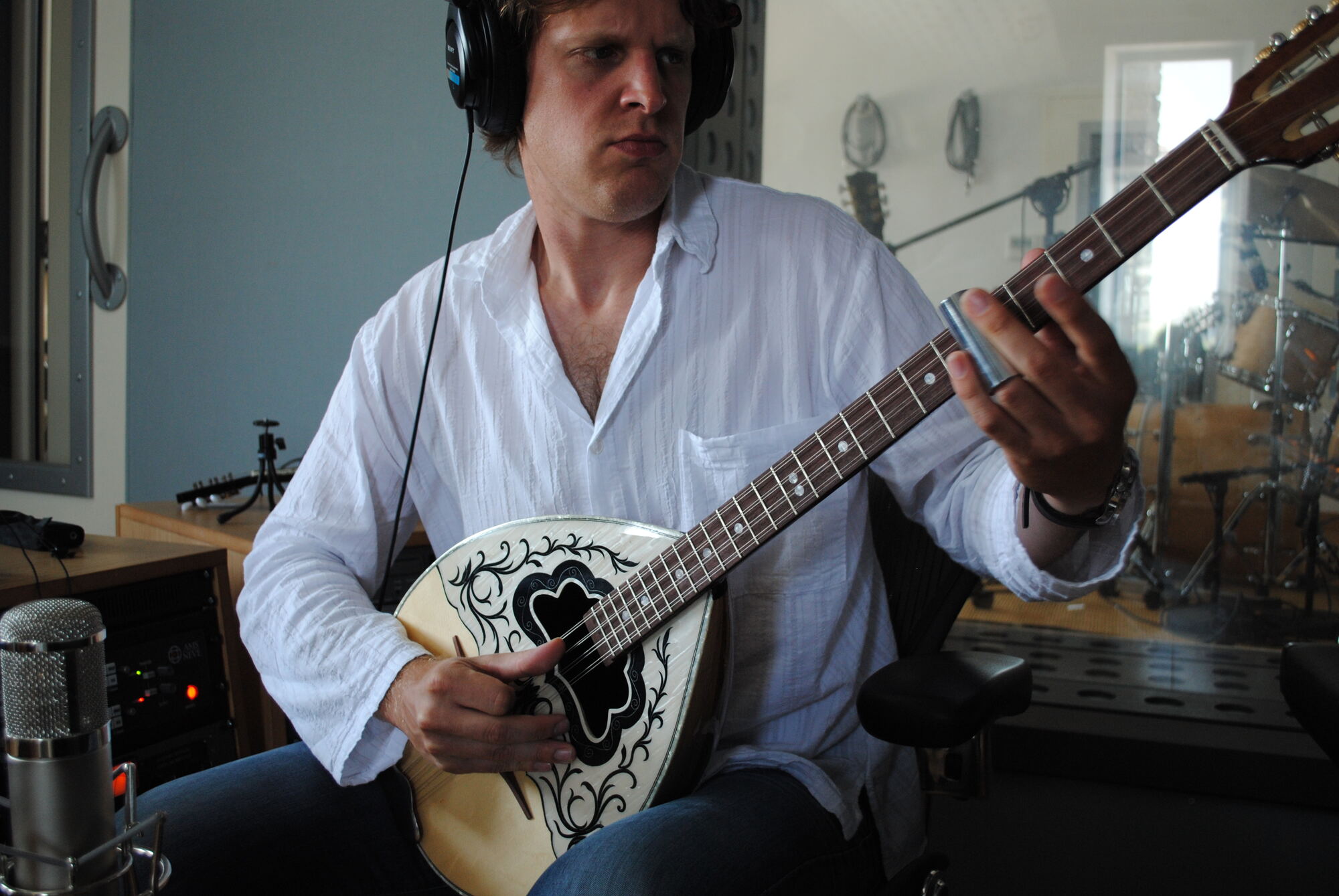 A musician recording bouzouki in the live room in Santorini