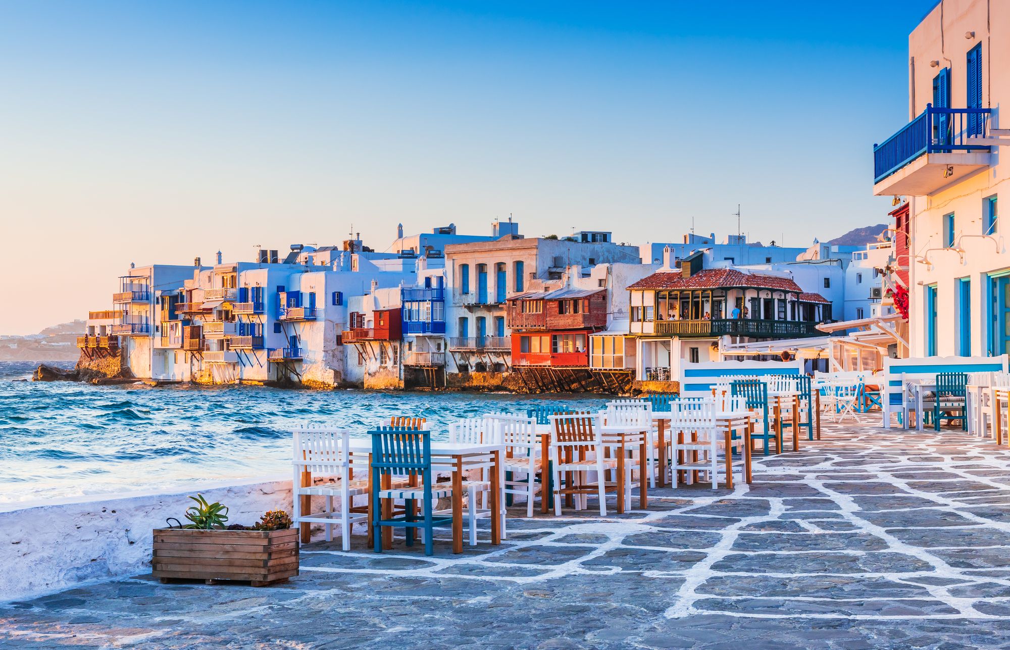 Houses of Little Venice standing over the sea, tables and chairs on the waterfront at sunset