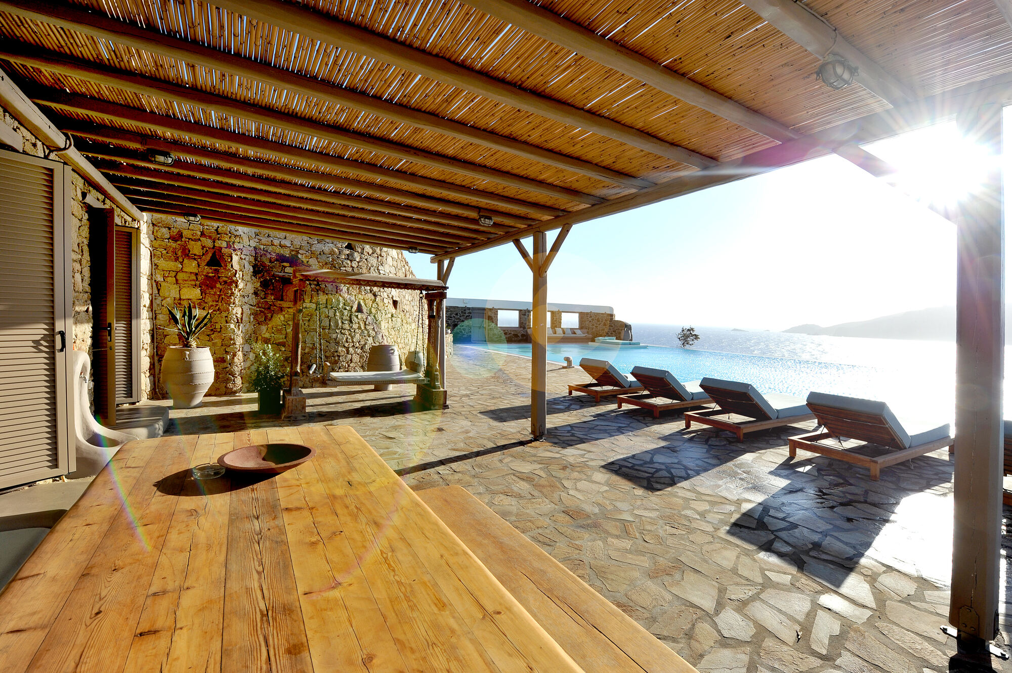 The shaded terrace beside the infinity pool